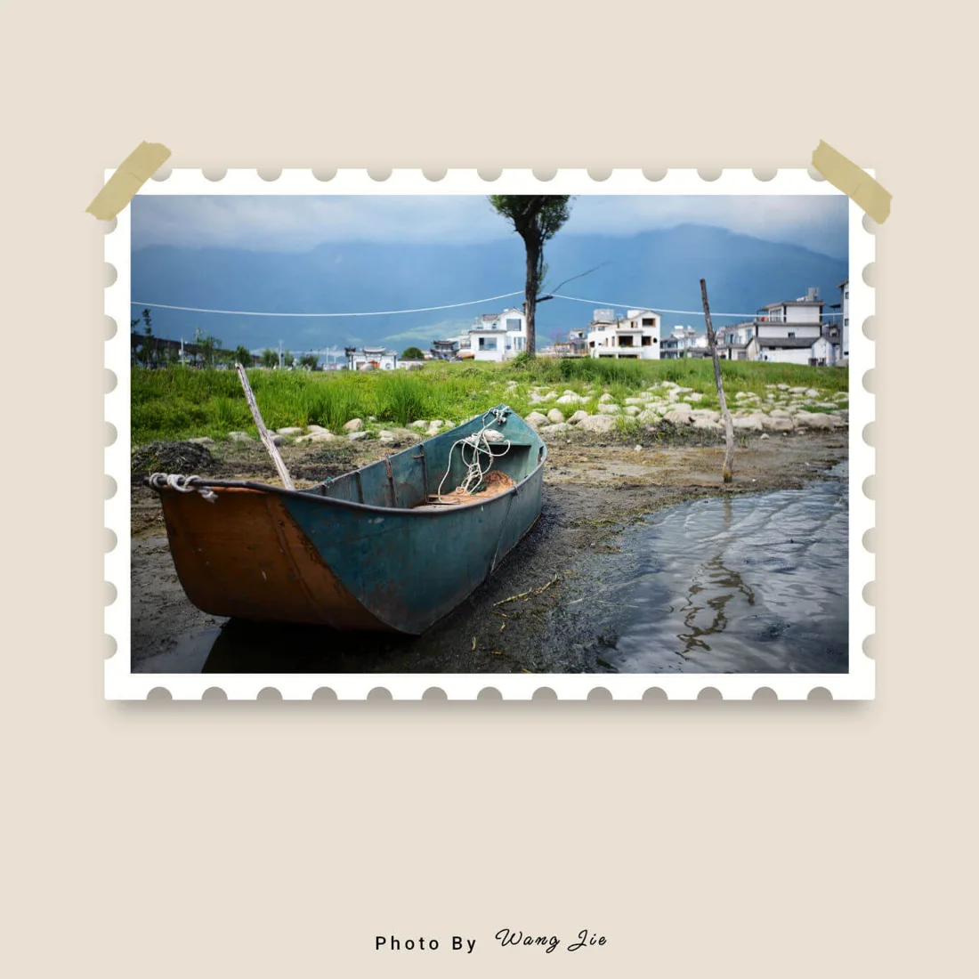 Lake and boat photograph with a postage-stamp border